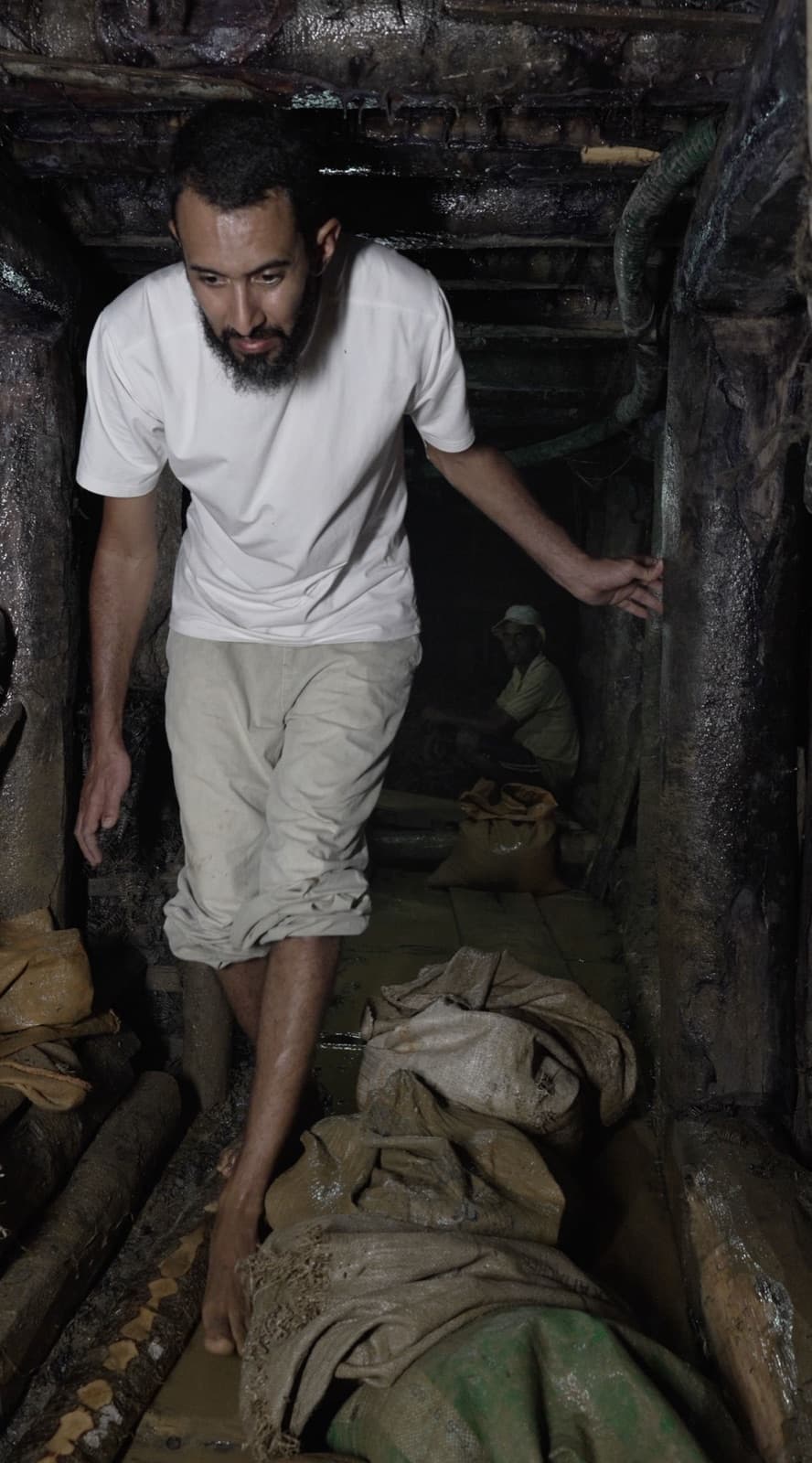 Elias descending into a gem pit, Sri Lanka