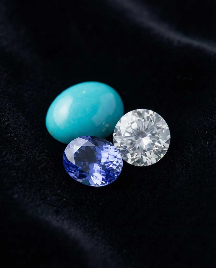 Three-panel display showing sky-blue turquoise with matrix, violet-blue tanzanite, and brilliant blue zircon side-by-side