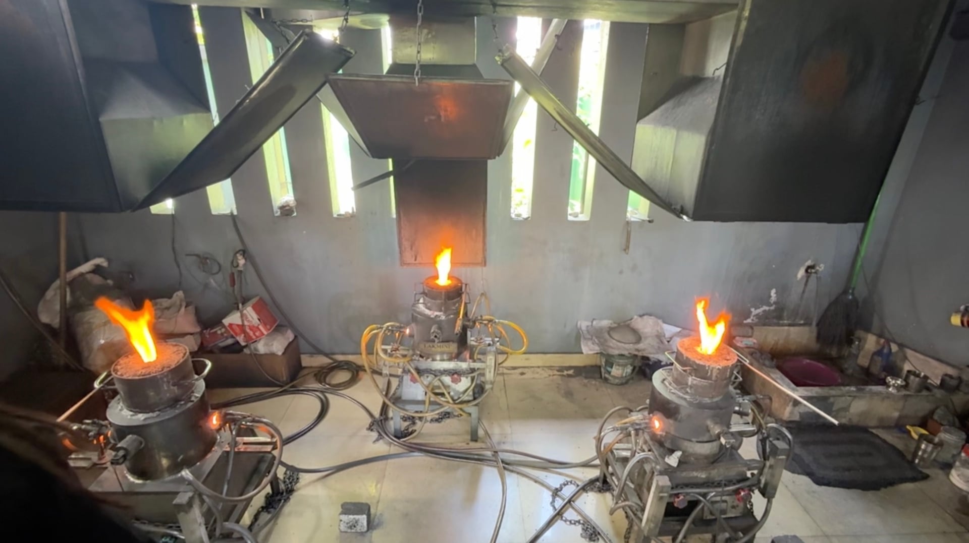 Real sapphire heat treatment furnaces with open flames in a workshop in Sri Lanka