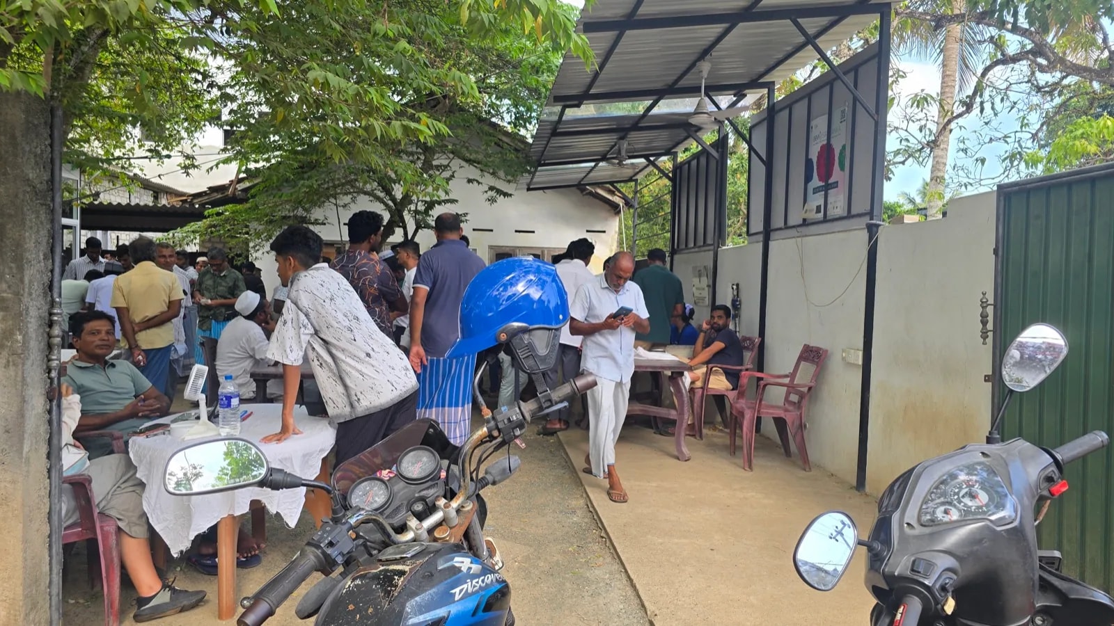 Dealers trading Ceylon sapphire parcels at tables in a Sri Lankan gem market