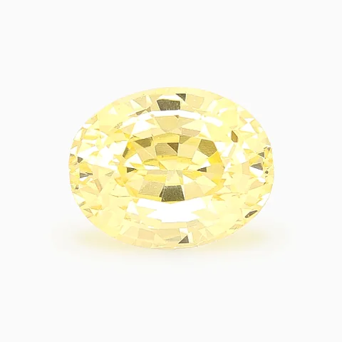 Loose pale yellow sapphire, oval cut, 1.56 ct, on a white ground